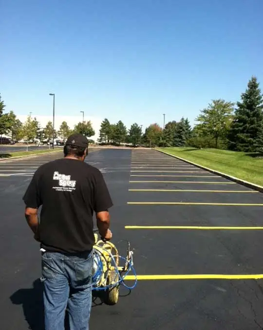 man striping a parking lot